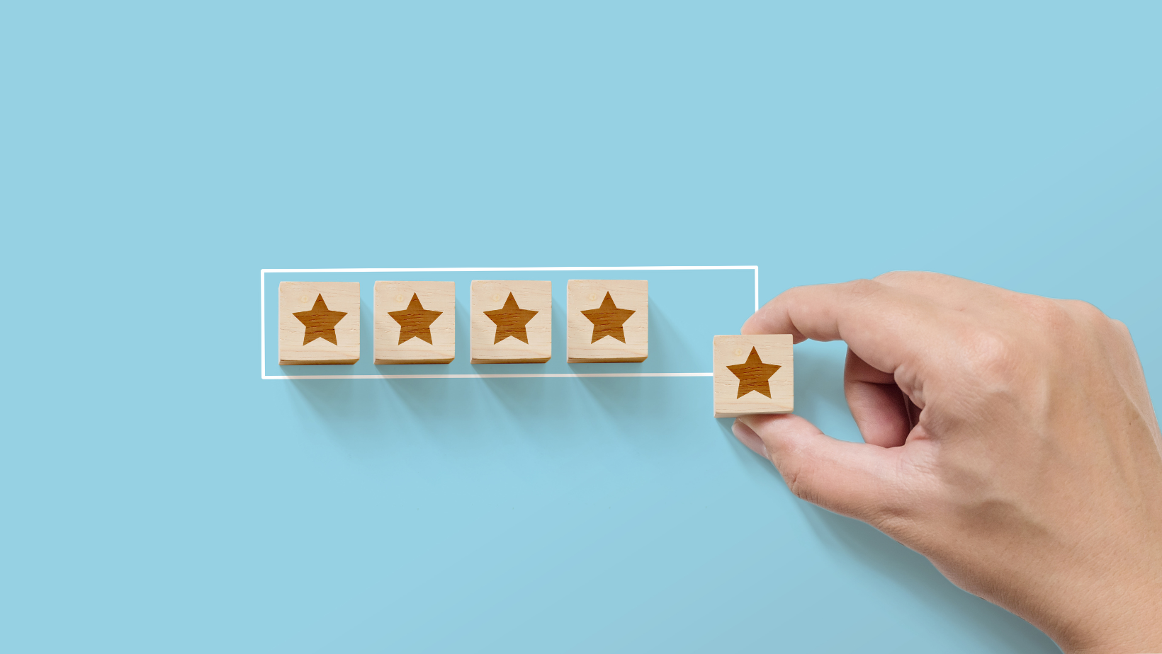 A hand placing the 5th star next to what used to be 4 stars.