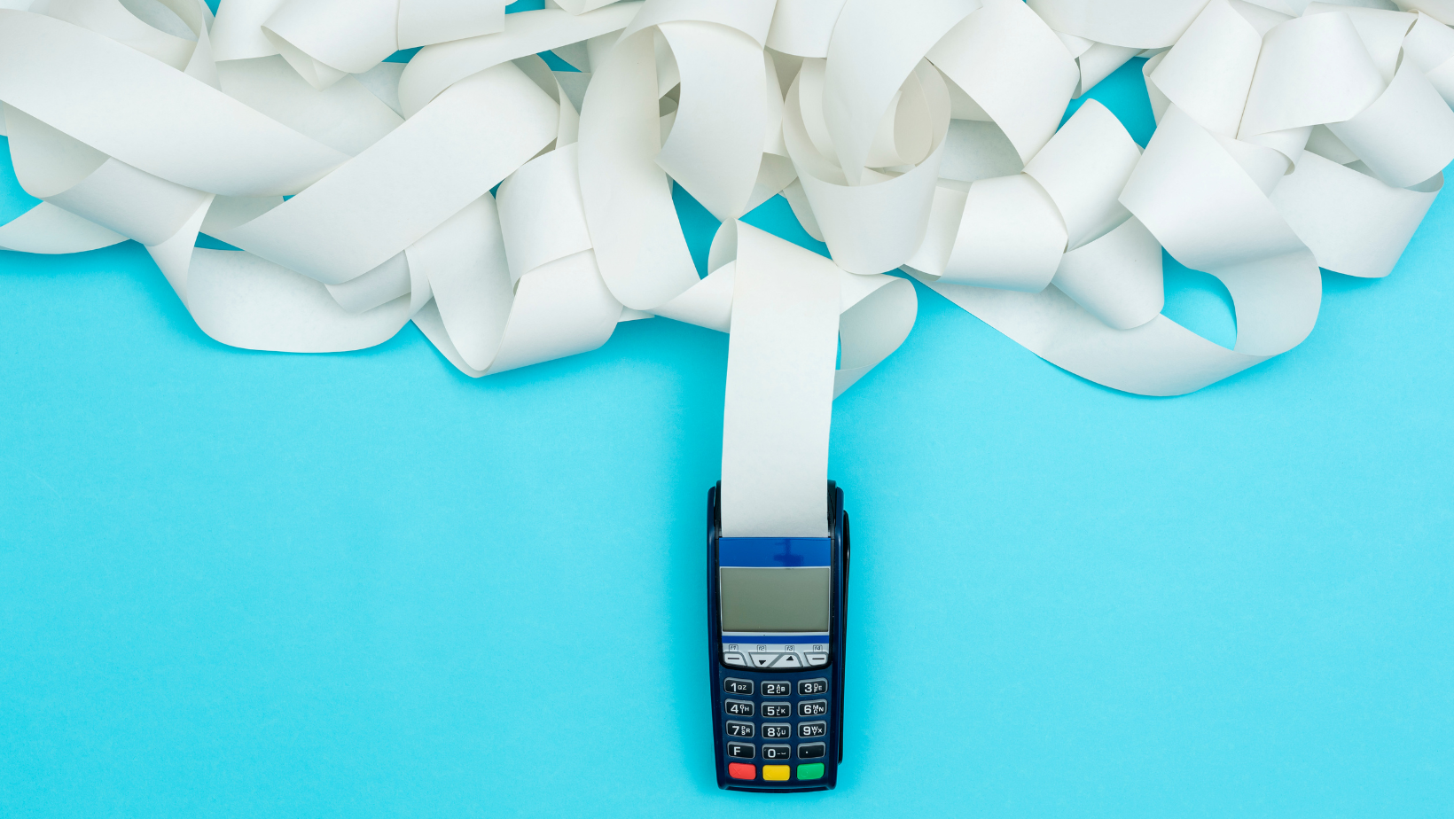 A debit terminal printing an extremely large receipt with the paper wrapping around itself.